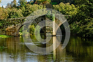 Medieval stone bridge over the Arnoia river in the town of Allariz, Ourense. Galicia, Spain photo