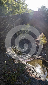 Medieval Stone Bridge with stream flowing underneath it