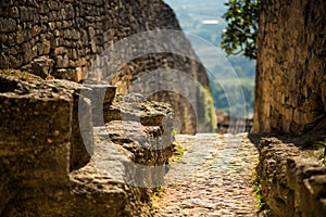 Medieval stone wall of castle of notorious Marquise de Sade in Lacoste, Provence, France. Ruins of old castle in Europe in hot