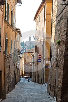 Medieval street and old houses in Siena, Italy