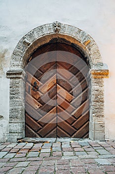 Medieval style wooden door with stone arch