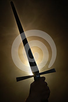 Medieval sword silhouette at backlighting photo