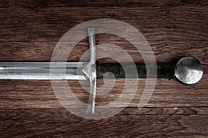 Medieval sword on wooden backgrond