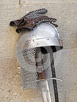 Medieval swords, knight helmet and chain mail gloves.