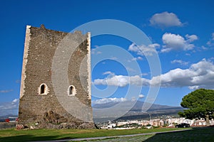 Medieval tower with mount Etna in background