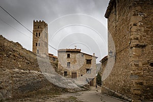 Medieval tower and old houses in Villarroya de los Pinares