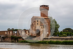 Medieval tower Torre Guelfa, on the banks of the river Arno, in the Citadella area of Pisa, Tuscany, Italy