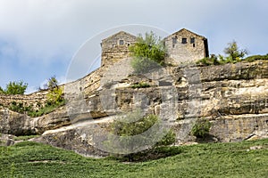 Medieval towers on a high cliff above the mountain valley in the famous ancient city-fortress Chufut-Kale, Russia