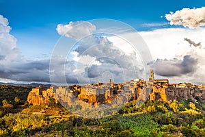 Medieval town of Pitigliano with dramatic cloudscape at sunset, Tuscany