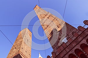 The medieval Two Towers of Bologna, Garisenda and Asinelli, stand as sentinels of time, their imposing brick facades a signature
