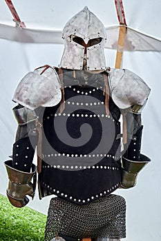 Medieval vintage armor and retro warrior helmet. Reconstruction of the events of the Middle Ages in Europe