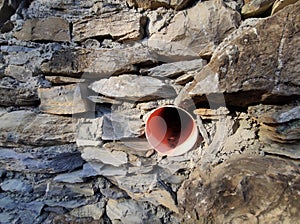 Medieval wall of alley of Sant Ilario Genoa Italy with new water pipe photo