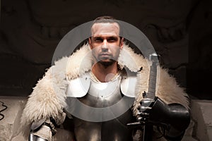 Medieval warrior in armor and fur mantle