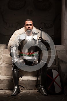 Medieval warrior in armor and fur mantle