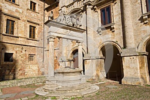 Medieval well on the city square of old Montepulchano. Italy