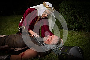 Medieval widow crying over dead knight