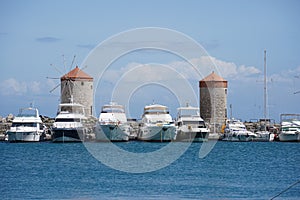 Medieval windmills of Rhodes town. Mandraki Harbour in the Dodecanese island of Rhodes Greece