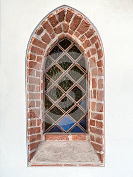 Medieval window with stained glass in historical church