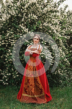 Medieval woman in blooming garden
