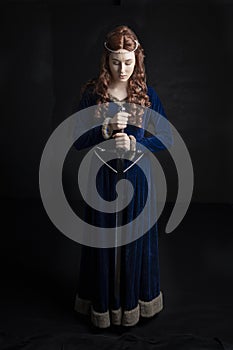 Medieval woman in a blue velvet dress