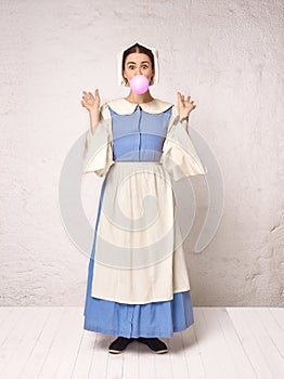 Medieval Woman in Historical Costume Wearing Corset Dress and Bonnet.