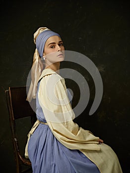 Medieval Woman in Historical Costume Wearing Corset Dress and Bonnet. photo