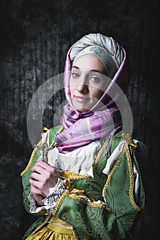 Medieval woman holds a Catholic cross.