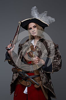 Medieval woman pirate with saber and handgun