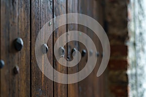 Medieval wooden door with decorative metal fittings.