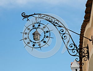 Medieval wrought iron shop sign in shape of lanter