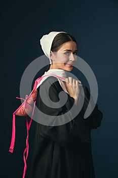 Medieval young woman as a nun with bra