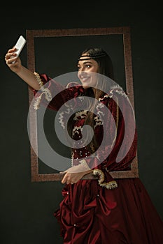 Medieval young woman in old-fashioned costume