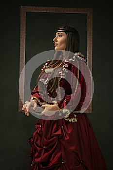 Medieval young woman in old-fashioned costume