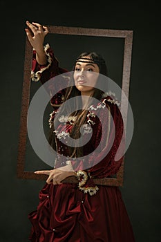 Medieval young woman in old-fashioned costume