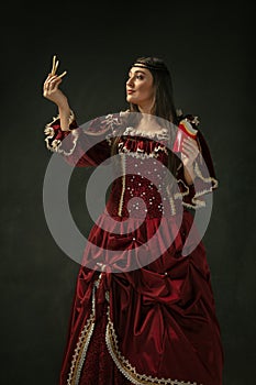 Medieval young woman in old-fashioned costume