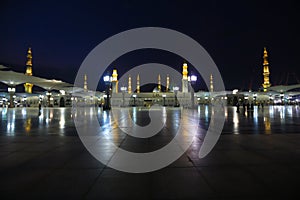 Muslims marching in front of the mosque of the Prophet Muhammad photo