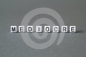 Mediocre - word concept on cubes photo