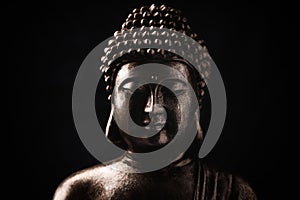 Meditating Buddha Statue on dark background. Close up.