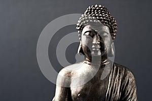 Meditating Buddha Statue on dark background. Close up.