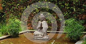 Meditating Buddha statue in a garden