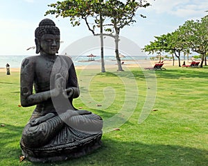 Meditating Buddha statue on Nusa Dua beach in Bali Indonesia