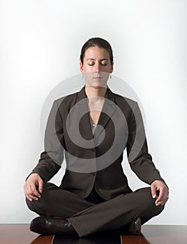 Meditating business woman