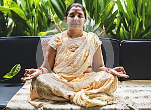 A meditating senior Indian woman