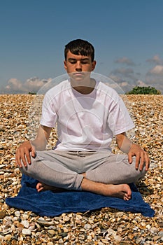 Meditating on a stony beach