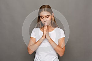 Meditating woman with praying hands portrait