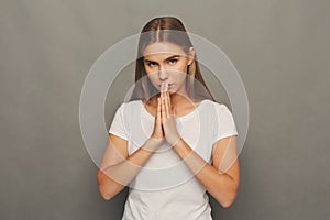 Meditating woman with praying hands portrait