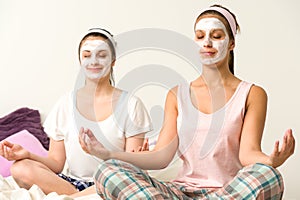 Meditating women wearing white facial mask