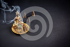 Meditation background with  buddha incense holder and burning aromatic cone