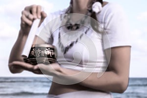 MEDITATION ON THE BEACH with tibetan bell photo