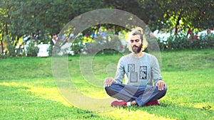 Meditation in everyday life conditions. Concept. Portrait of a young male in casual clothes practicing meditation and